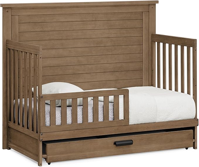 Delta Children Simmons Kids Caden 6-in-1 Convertible Crib with Trundle Drawer, Greenguard Gold Certified, Aged Oak-CubbioJoy