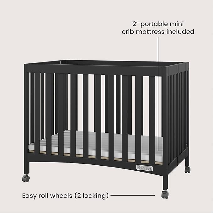 Child Craft London Mini Compact Folding Portable Crib with 2” Crib Mattress and 2 Easy Roll Locking Wheels, Durable Pine Wood Construction (Ebony Black)-CubbioJoy