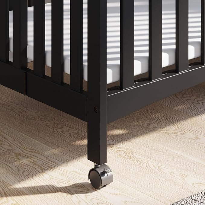Child Craft London Mini Compact Folding Portable Crib with 2” Crib Mattress and 2 Easy Roll Locking Wheels, Durable Pine Wood Construction (Ebony Black)-CubbioJoy