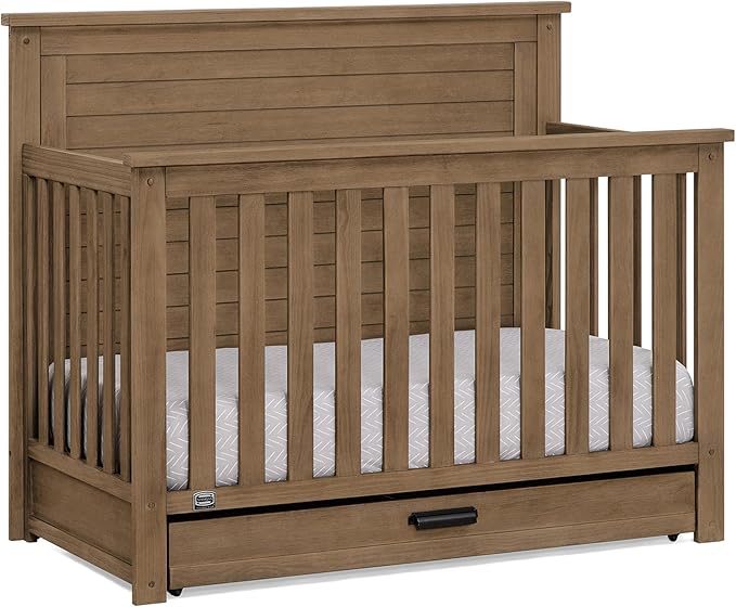 Delta Children Simmons Kids Caden 6-in-1 Convertible Crib with Trundle Drawer, Greenguard Gold Certified, Aged Oak-CubbioJoy