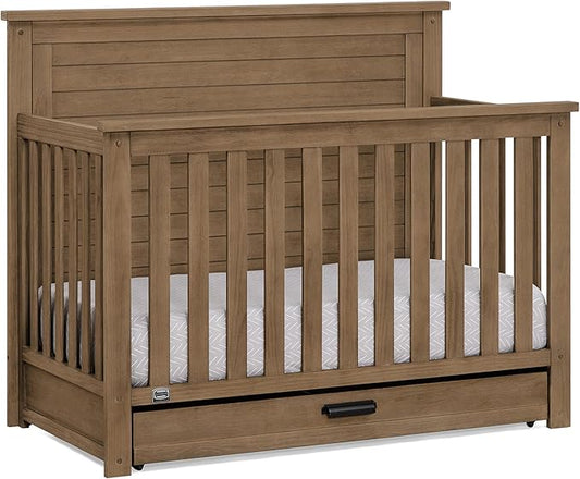 Delta Children Simmons Kids Caden 6-in-1 Convertible Crib with Trundle Drawer, Greenguard Gold Certified, Aged Oak-CubbioJoy