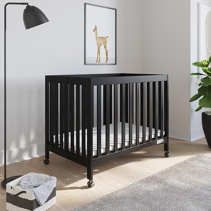 Child Craft London Mini Compact Folding Portable Crib with 2” Crib Mattress and 2 Easy Roll Locking Wheels, Durable Pine Wood Construction (Ebony Black)-CubbioJoy